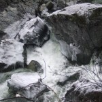 Icy rocks kept clear only by the rapids